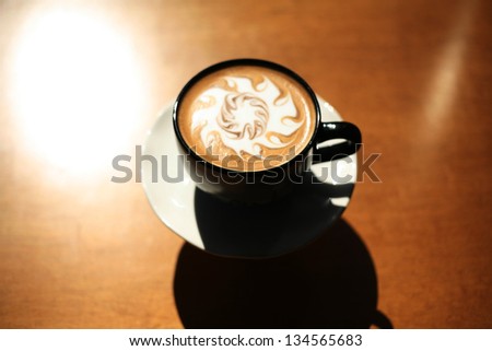Latte Art, Designs drawn with steamed milk in hot fresh rich coffee in a ceramic coffee cup.