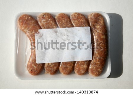Fresh Raw Chicken Sausages in their package from the butcher shop with a blank white label with room for your text or images