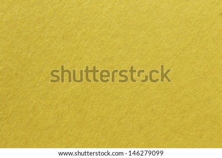 close up aka macro shot of yellow construction paper, showing texture, paper fibers, flaws, and more. the perfect image for all your colored construction or recycled paper needs
