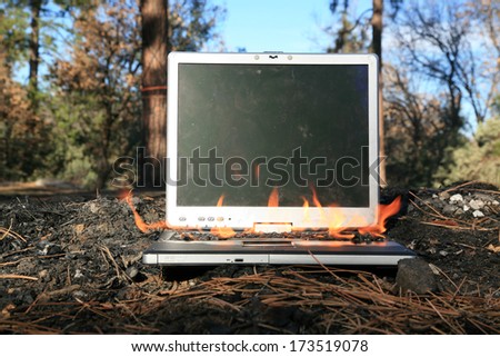 A genuine Lap Top Computer completely engulfed in flames of fire.  Computer damage due to a person typing so fast they burned up the internet or were writing something so HOT it literally caught fire
