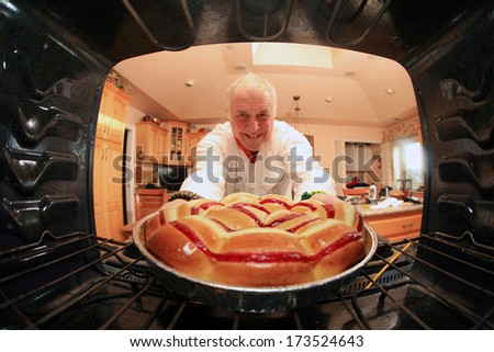A Man bakes his signature Smiley Face Cookies in his oven for his hungry family and friends. Shot from the Inside of the oven facing out showing a unique view not often seen.