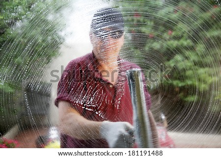 A friendly and professional a window washer soaps and cleans a window with a squeegee, leaving them Squeaky Clean. Everyone Loves Clean Windows especially in the Spring and Summer Season.