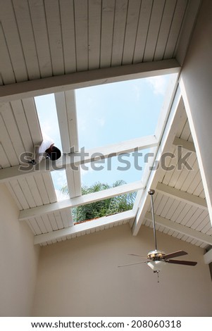 The interior of a home with everything covered in protective heavy plastic due to major roof reconstruction and removal of a 10 foot skylight. Heavy plastic is important to keep furniture clean