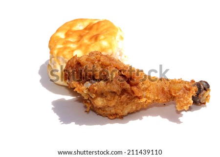 A fried Chicken Leg and Biscuit isolated on white with room for text. Fried chicken is enjoyed by people around the world. Flour Biscuit are good with fried chicken. The perfect Lunch or Dinner image.