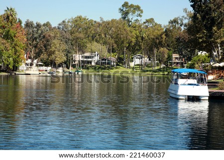 Private Lake with homes and boats in Lake Forest California. Lake Forest has many Private Lakes with limited access to the general public, making it an ideal and serene location to live life.
