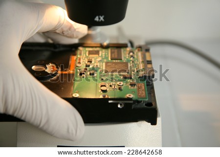 A Genuine Computer Hard Drive is repaired with the help of a Microscope. Microscopes are used to see images up to 400 times larger than with the naked eye, revealing defects and damage for repair