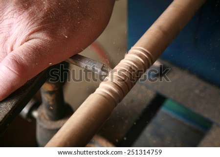 A wood worker works on a project on his lathe. Lathes are used by wood workers and metal workers for all sorts of projects around the world. Wood Working is a business and a hobby enjoyed by millions