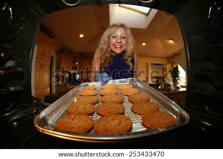 Hot and Fresh COOKIES right from the oven!  A lady bakes cookies for a charity bake sale to help raise money for a Wounded Solders.