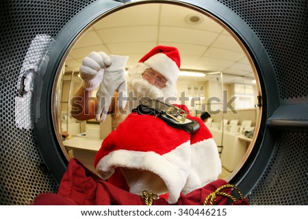 Santa Claus washes his own clothes at the Laundromat before Christmas. Focus on Santa\'s Clothes. Shot with a Fish eye Lens from the Inside out for a Unique and Funny View unseen by anyone until now.