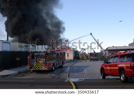 HARBOR GATEWAY, CALIFORNIA- DECEMBER 12, 2015: Fire erupts at recycling yard in Harbor Gateway. Dozens of Fire Trucks arrive to help extinguish an industrial fire, California Dec. 12, 2015