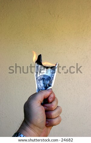 Money To Burn!\
\
A hand holding a Twenty Dollar Bill on fire.