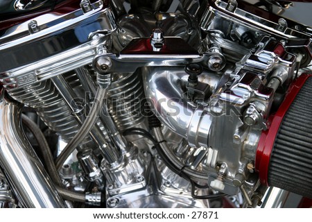 a great view of a chromed v-twin motorcycle engine with a large air cleaner attached