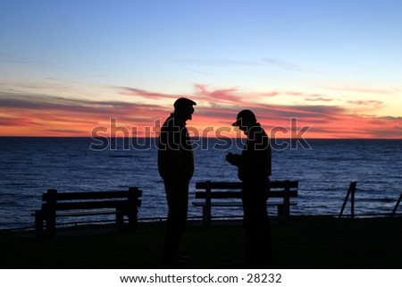 two friends chat in the setting sun in laguna beach california the evening before a major rain storm rolled in