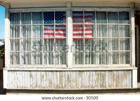 an american flag is proudly displayed in an old wooden window with old curtins showing that no matter how old you are you can still be proud to be an American!