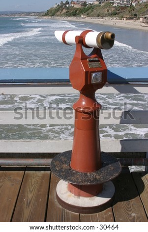 a pay telescope sits upon a dock waiting for someone to put a quarter in and see what they can see