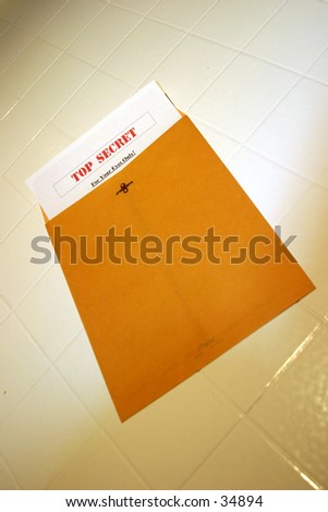 A Top Secret (for your eyes only) document peeks out of a manila envelope