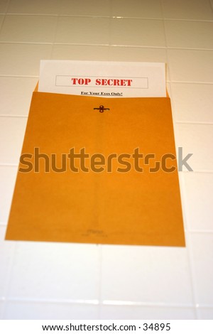 A Top Secret (for your eyes only) document peeks out of a manila envelope