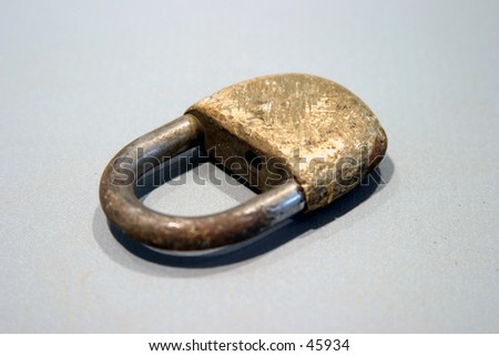 an old worn out lock on a gray background