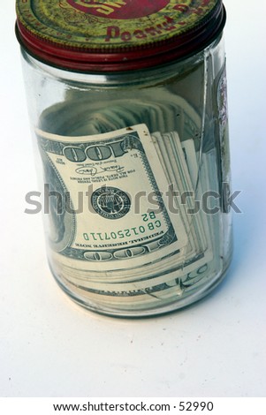 american cash in an old glass jar with a rusty lid and a crack in the glass