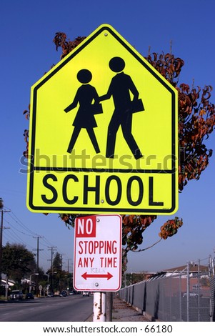 yellow school crossing sign with no parking any time sign attached