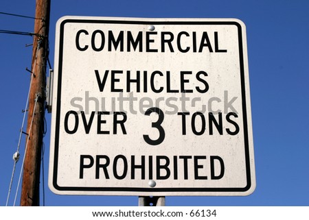 commercial vehicles over 3 tons prohibited sign against a blue sky