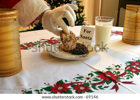 Santa Claus takes a cookie kindly left for him from a nice lady with a nicely typed note on x mas eve