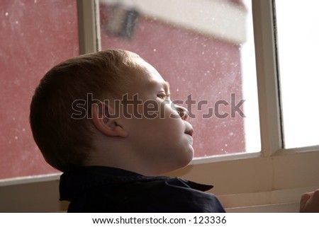 My grandson looks out a window