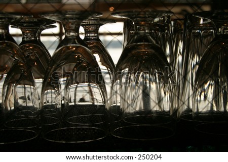 wine glasses hanging upside down through a window
