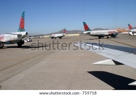 A busy airport from the ground with airplanes ready for take off