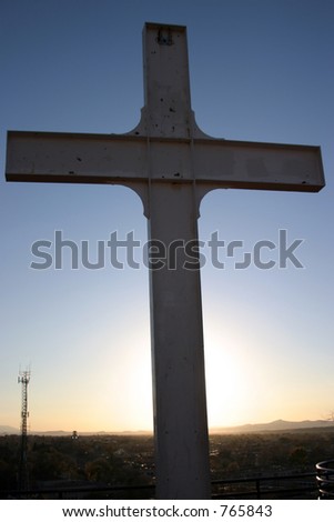 old cross with sunset in background