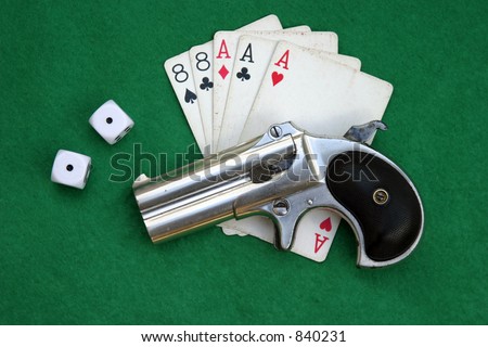 â€œCirca 1889, Model 95, Type II Model 3 Double Derringerâ€� lays ontop of Aces and Eights with shells and snake eyes dice