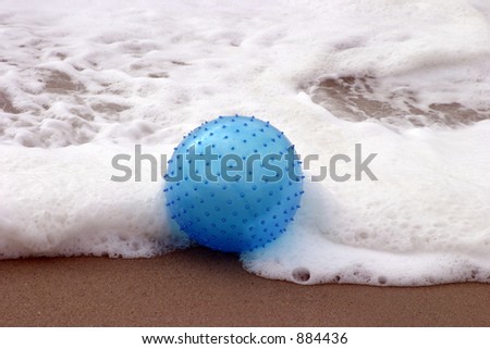 spikey blue beach ball in ocean waves