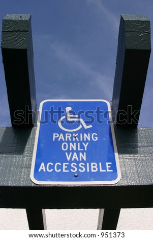 handicap sign with blue sky in background