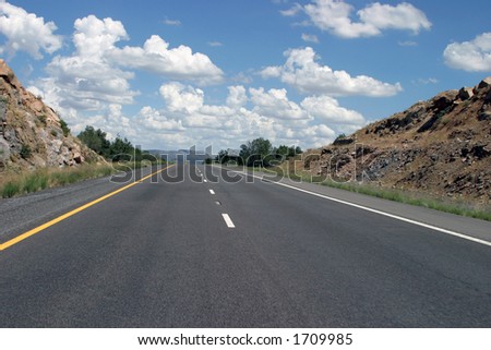 Highway with blue sky and vanishing point