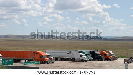 various semi-trucks at a truck stop