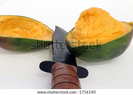 fresh cut mango with a military knife