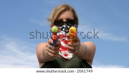 Girl with American Flag bandanna hold squirt guns at You