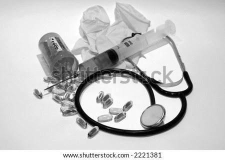 medical dental concepts with real human teeth, pills, hypodermic needle with green fluid, and a stethascope in black and white