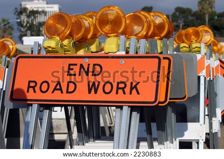caution traffic signs, orange safety cones and amber warning lights