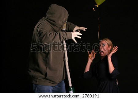 an innocent young woman shreaks in fear as she is about to be attacked by a gas mask wearing fiend in an apocylopic post nuclear future