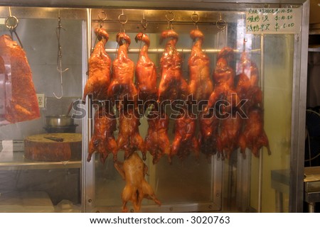 bbq duck and chicken hang on a rack in a chinese restaurant for sale