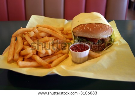 a lunch consisting of a Beacon Cheese Burger and Freedom Fries in a Drive In Diner with Ketchup