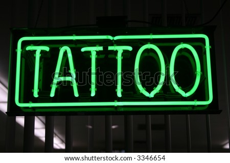 MA dealership your eyes are drawn to a bright "TATTOO" neon sign.
