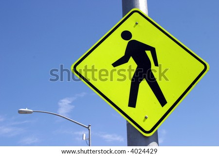 a cross walk sign in yellow