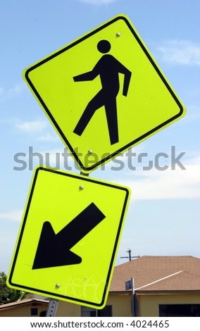 a cross walk sign in yellow