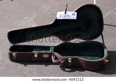 a farmers market series a guitar case with a tips for playing music sign