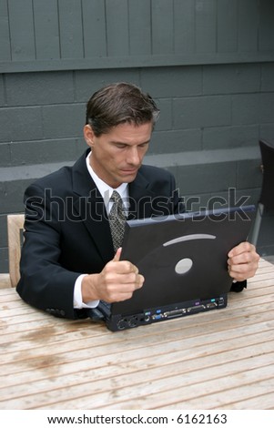 a business man expresses various emotions while working with his lap top computer, from frustration, to surprise, to confusion, to joy, happyness, tiredness and headaches in this series of concepts