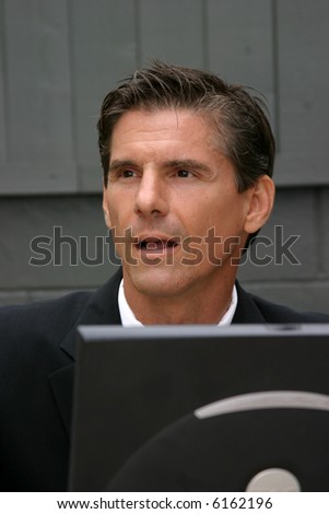 a business man expresses various emotions while working with his lap top computer, from frustration, to surprise, to confusion, to joy, happyness, tiredness and headaches in this series of concepts