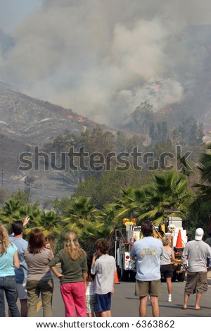 people watch from Portola hills as their and their neighbors homes and yards burn to the ground in the Santiago Canyon Wild Fires in California