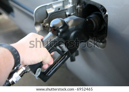 pumping gas into a car